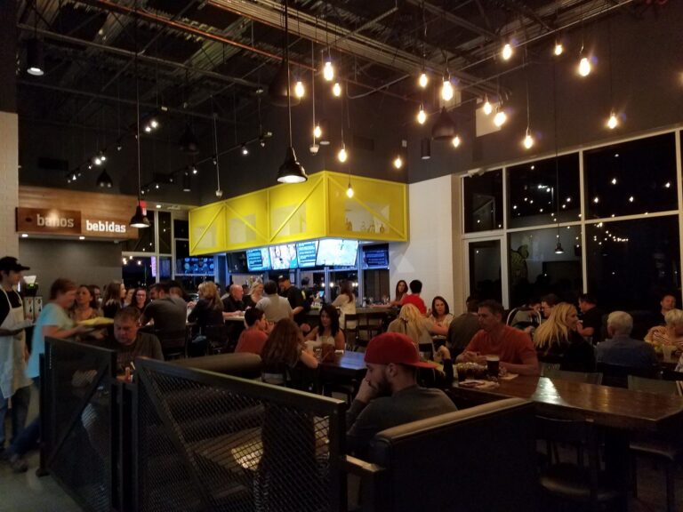 A full restaurant of people eating, talking and celebrating the restaurant's grand opening at LIMoN Urban Kitchen. A full restaurant of people eating, talking and celebrating the restaurant's grand opening at LIMoN Urban Kitchen.